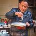 Street market vendor cooking outdoor.